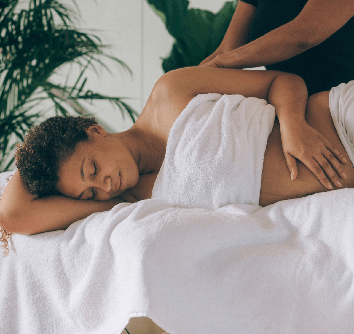 Pregnant person relaxes on the massage table