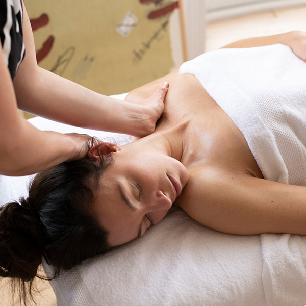 Hands massaging woman's neck and shoulders