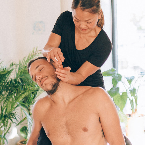 Therapist giving a thai massage to a patient 