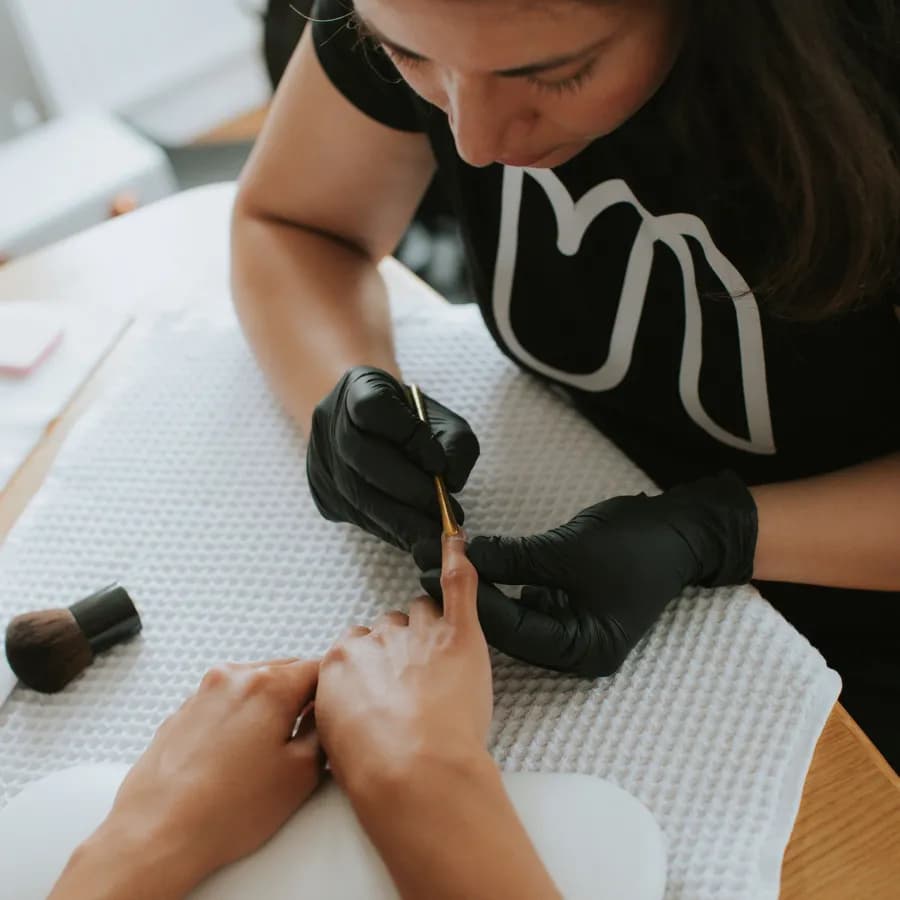 Nail specialist pushes back cuticles