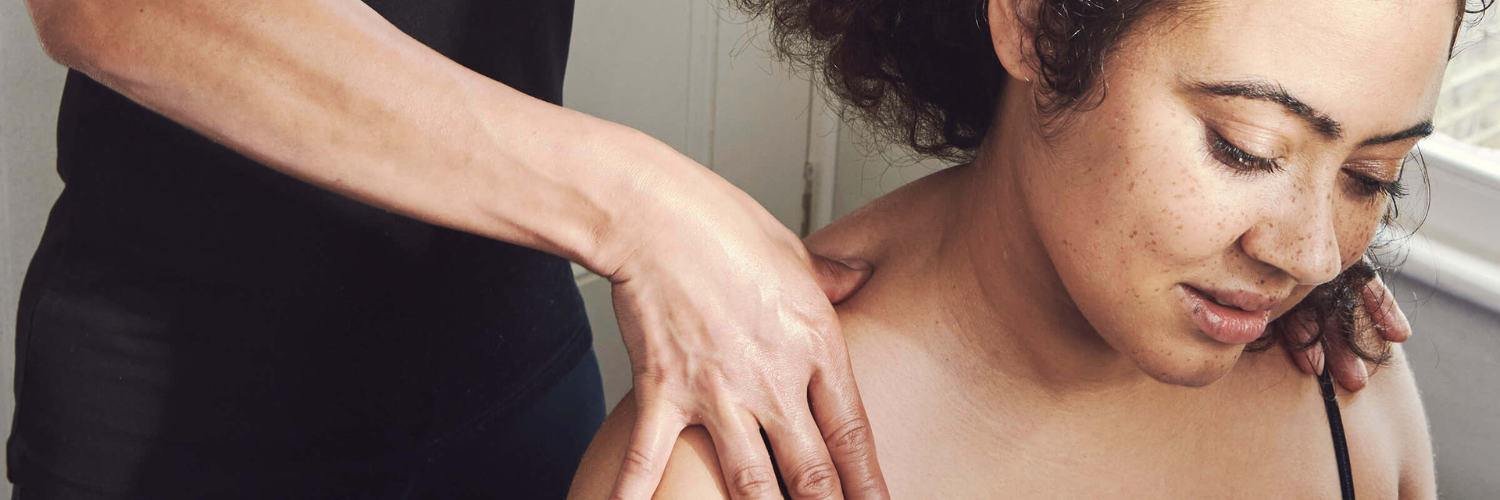 Woman enjoying a neck massage from a therapist