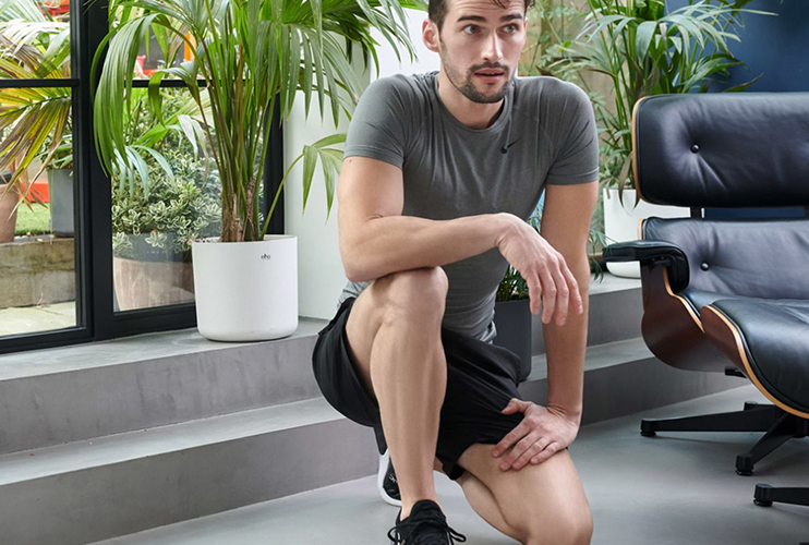Man at home with freshly waxed legs