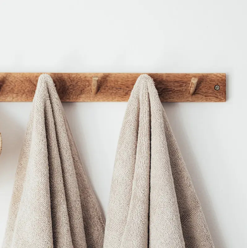 Towels hang side by side in London apartment in preparation for a couples massage